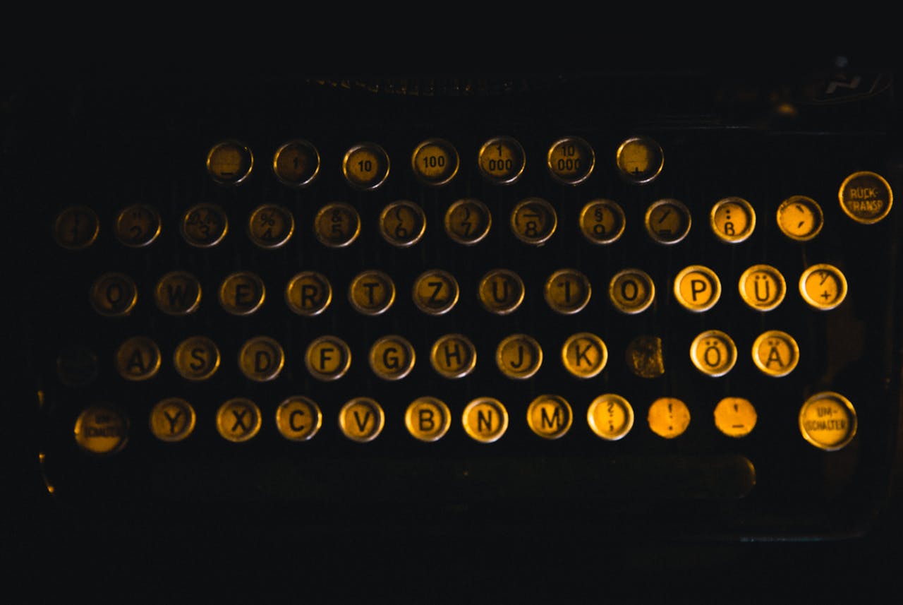 Crafting Captivating Headlines: Your awesome post title goes here Close-up image of vintage typewriter keys with German letters in low light ambiance.